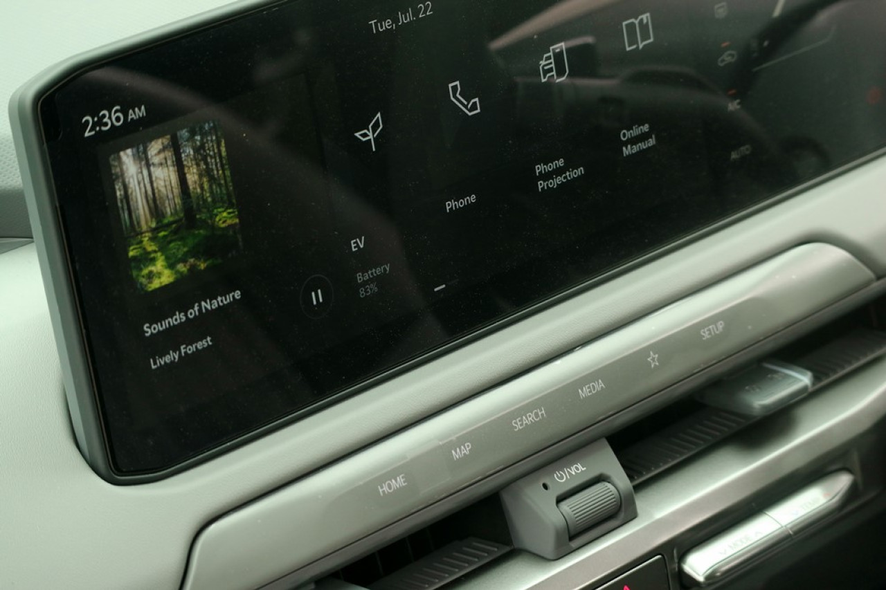 設計師沒有把 function keys 全數放入12.3吋的中控螢幕之內，而是巧妙地把部分功能鍵融入車廂飾件之中